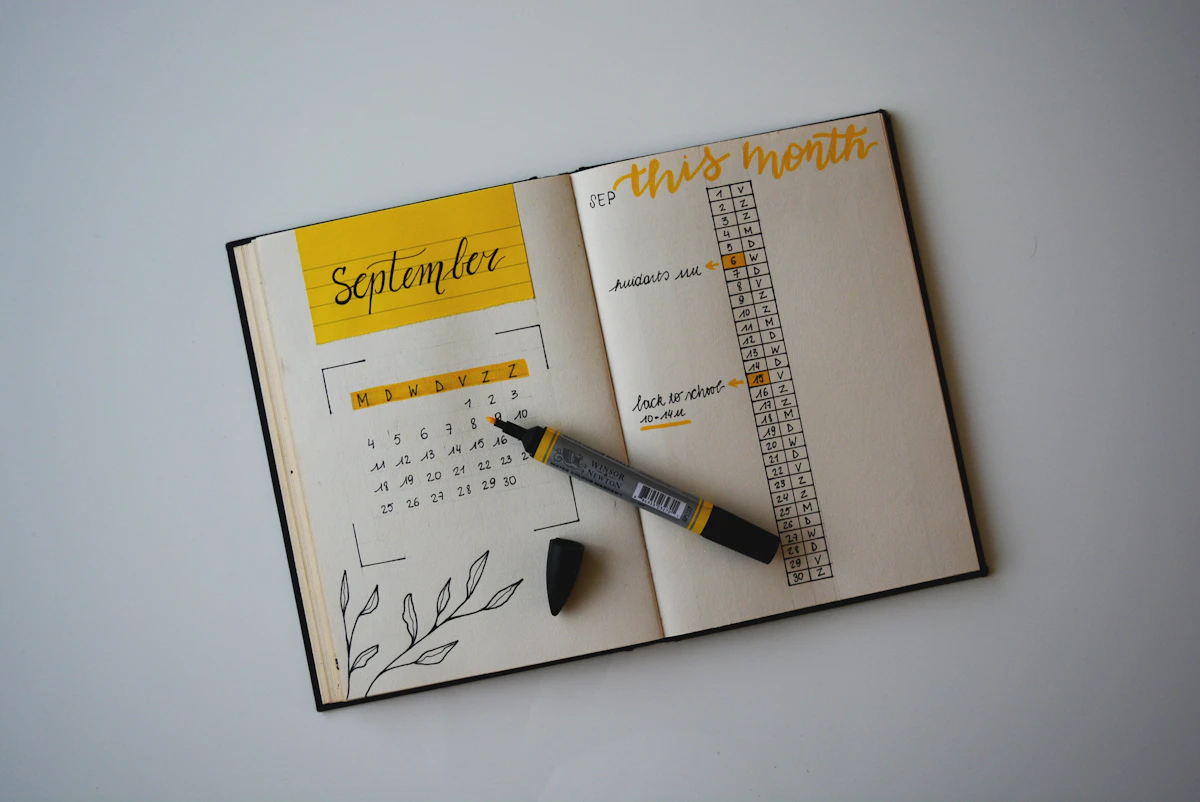 White budget planner open with a pen on top
