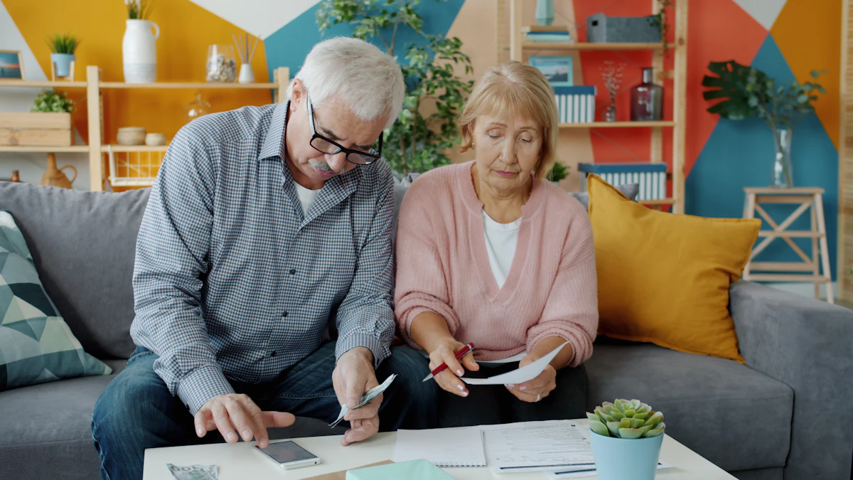 Elderly couple reviewing financial documents at home